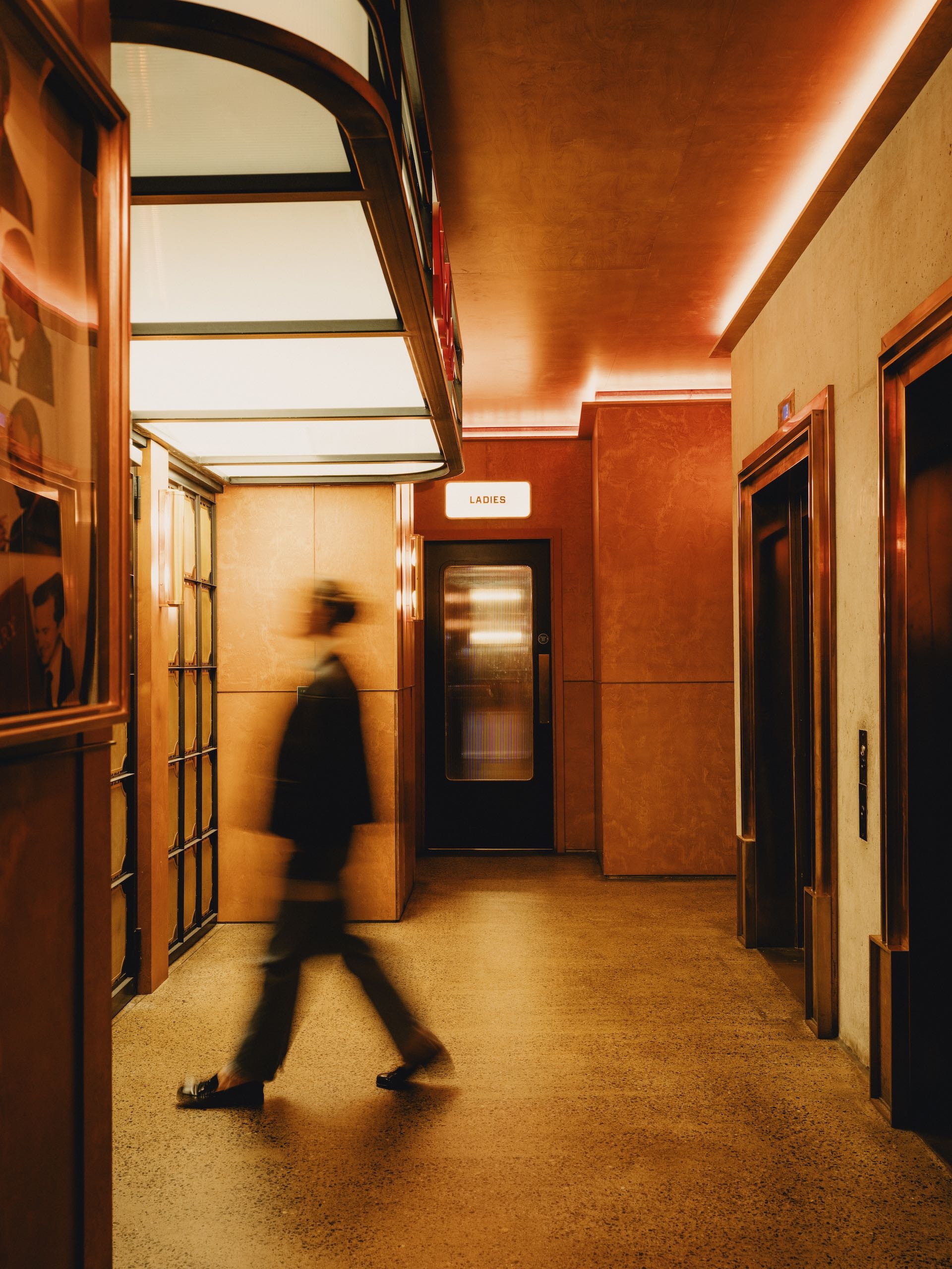 A person walking past a washroom
