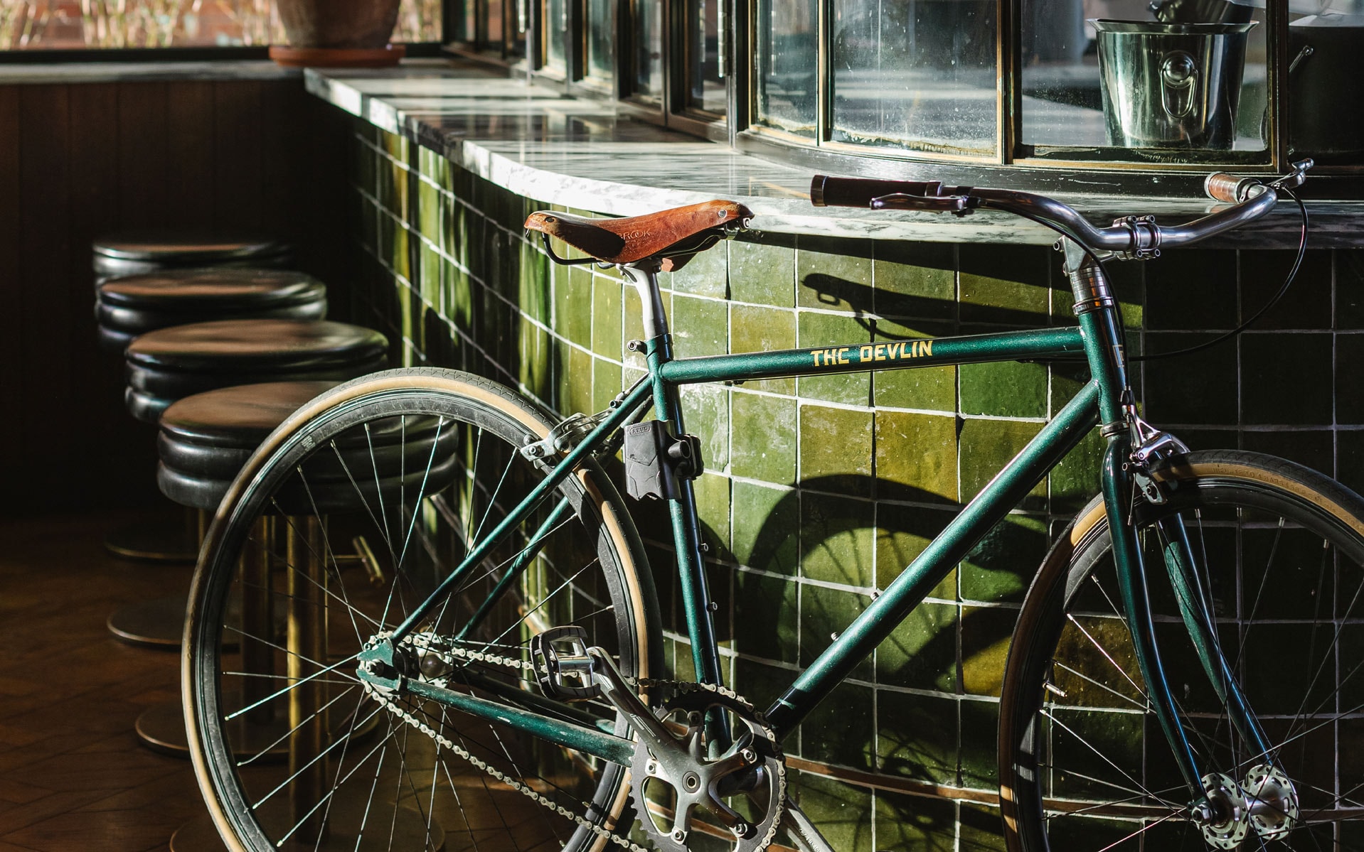 A green bicycle that has "The Devlin" written in yellow